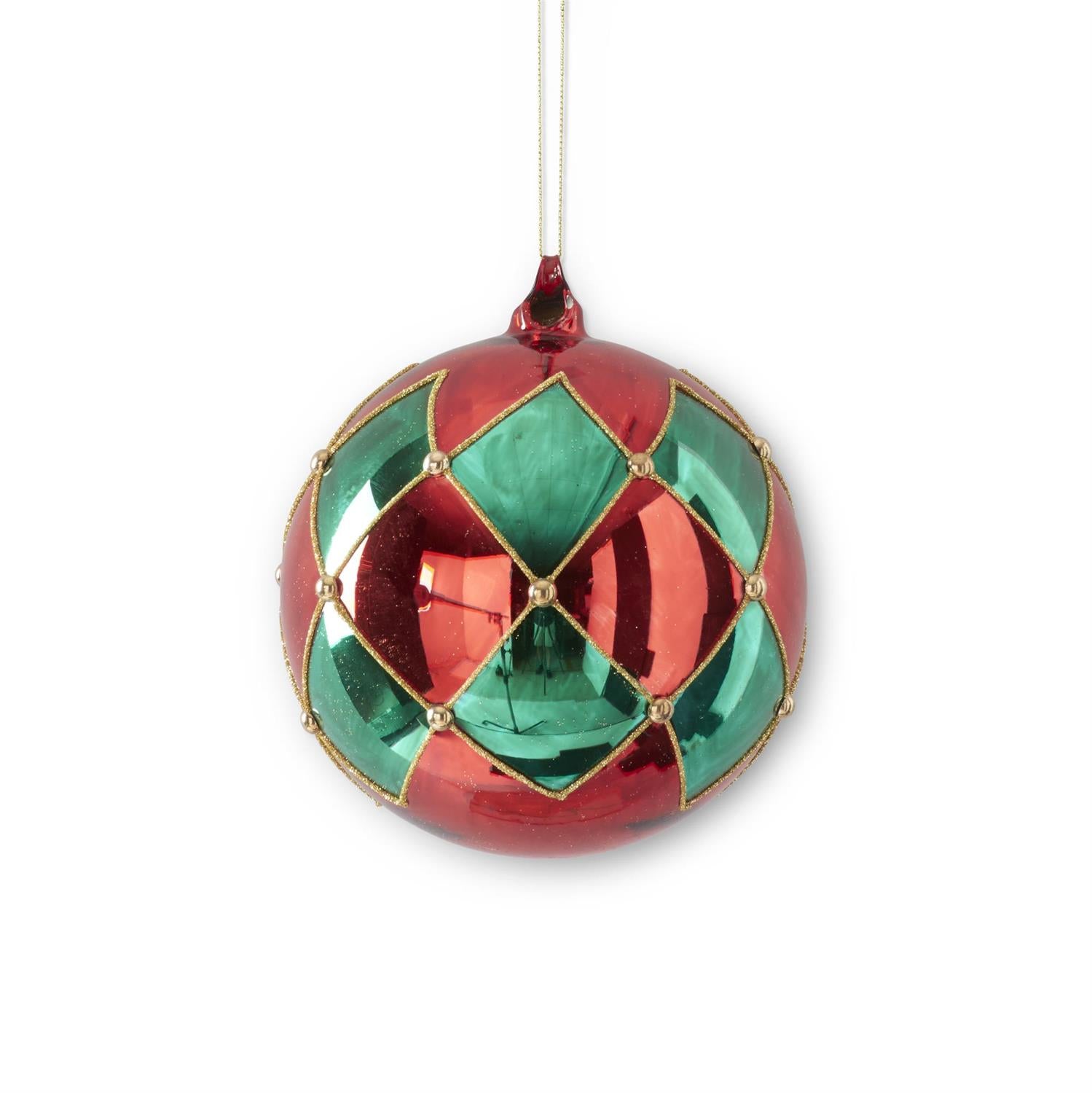 A round Christmas ornament with a glossy red and green harlequin diamond pattern, outlined in gold-toned metal and suspended by a thin white string against a white background.