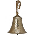 A hammered metal bell decoration in a warm antique gold finish, suspended by a knotted natural jute rope hanger against a plain white background.